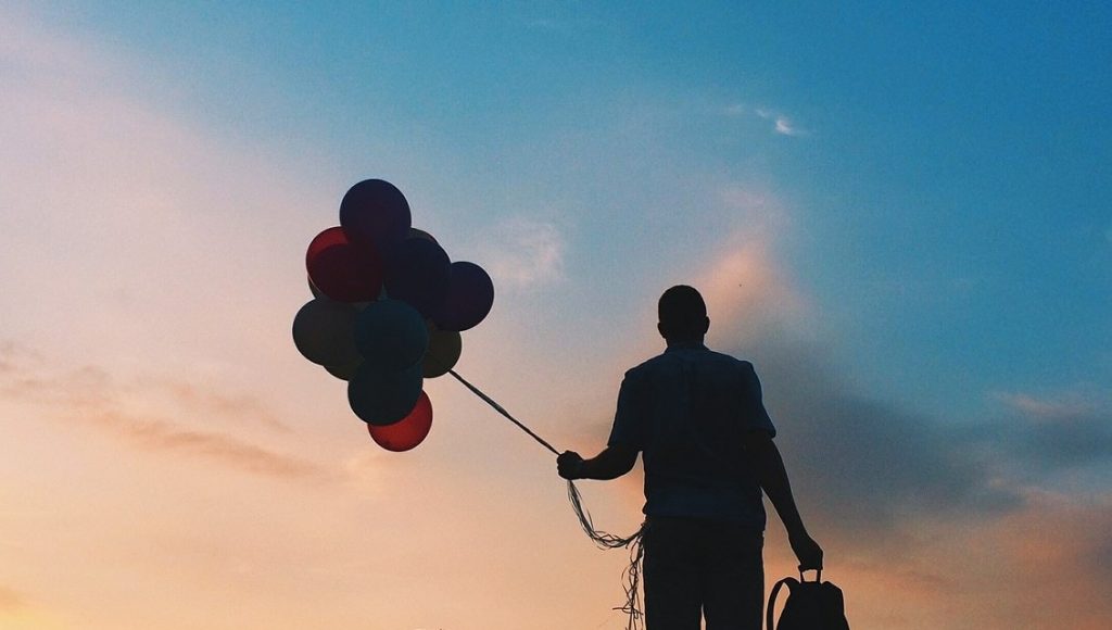 Man carrying balloons